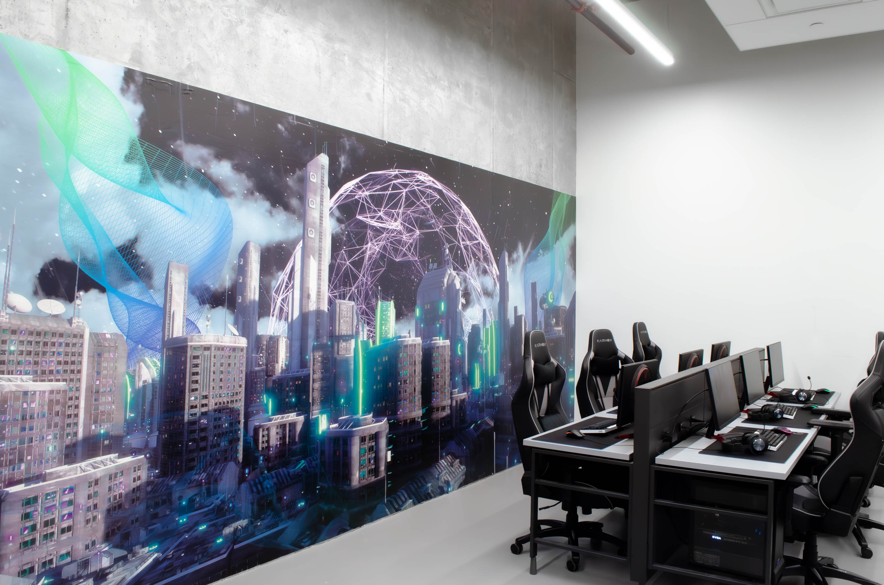 View of the mural at an angle, with computer stations in front.