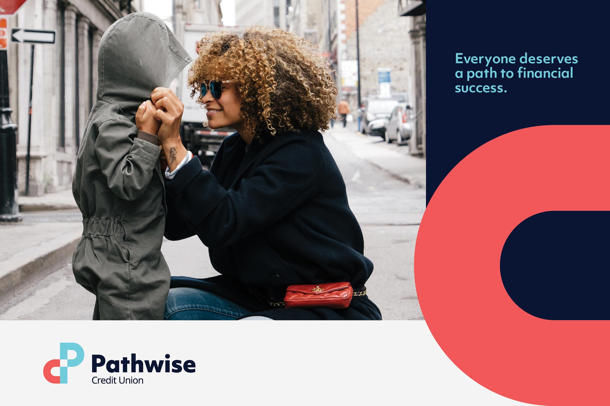 A postcard that features a young mixed mother holding hands with a child, and the phrase 'everyone deserves a path to financial success'.